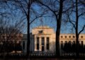 Fed cuts rates but sees slower pace of further reductions, firmer inflation