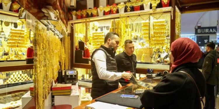 Gold edges up after US payrolls report, but heads for first weekly fall in five